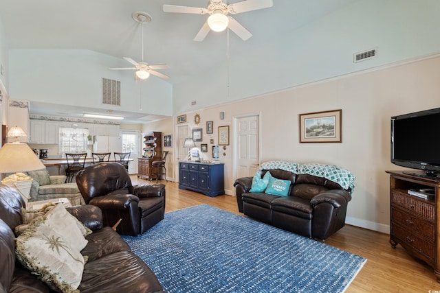 3307 Nixon St, North Myrtle Beach, SC 29582 - living room with ceiling fan, light wood-style floors, and high vaulted ceiling