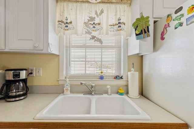 3307 Nixon St, North Myrtle Beach, SC 29582 - kitchen with light countertops, white cabinets, and freestanding refrigerator