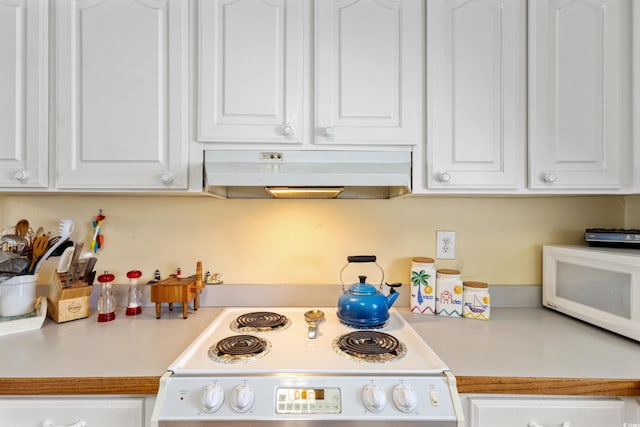 3307 Nixon St, North Myrtle Beach, SC 29582 - kitchen featuring range hood, range, white microwave, and white cabinets