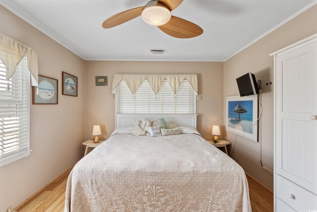 3307 Nixon St, North Myrtle Beach, SC 29582 - bedroom featuring wood finished floors, ornamental molding, and a ceiling fan