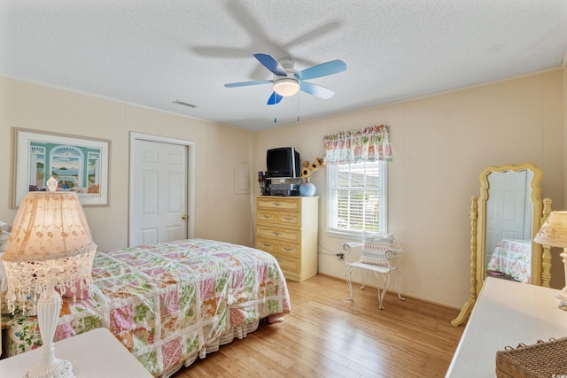 3307 Nixon St, North Myrtle Beach, SC 29582 - bedroom featuring light wood-style flooring, a textured ceiling, and ceiling fan