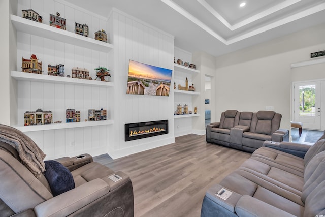 1024 Pochard Dr, Conway, SC 29526 - living room featuring built in features, wood finished floors, a glass covered fireplace, and recessed lighting