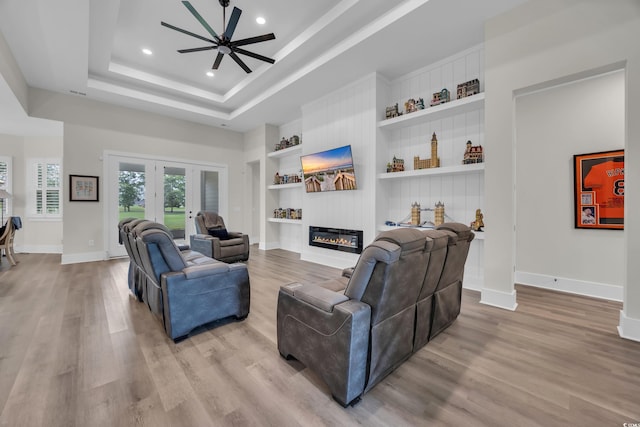 1024 Pochard Dr, Conway, SC 29526 - living room with wood finished floors, recessed lighting, built in features, french doors, and a tray ceiling