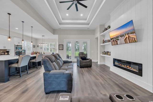 1024 Pochard Dr, Conway, SC 29526 - living area featuring built in shelves, ceiling fan, a raised ceiling, light wood-style flooring, and recessed lighting