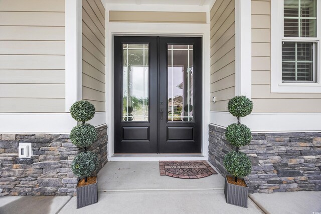 1024 Pochard Dr, Conway, SC 29526 - view of exterior entry featuring french doors and stone siding
