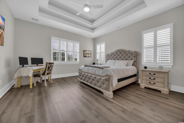 1024 Pochard Dr, Conway, SC 29526 - bedroom with a raised ceiling, wood finished floors, a desk, and ceiling fan
