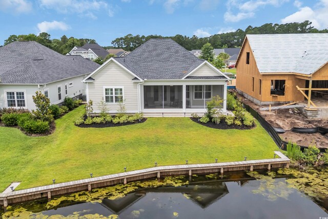 1024 Pochard Dr, Conway, SC 29526 - back of property with a sunroom, a shingled roof, a water view, and a lawn