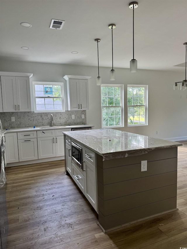 2075 Lees Landing Cir, Conway, SC 29526 - kitchen featuring stainless steel microwave, plenty of natural light, a kitchen island, tasteful backsplash, and recessed lighting