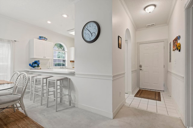 4261 Hibiscus Dr Unit 4-104, Little River, SC 29566 - foyer with crown molding, light colored carpet, arched walkways, recessed lighting, and light tile patterned floors