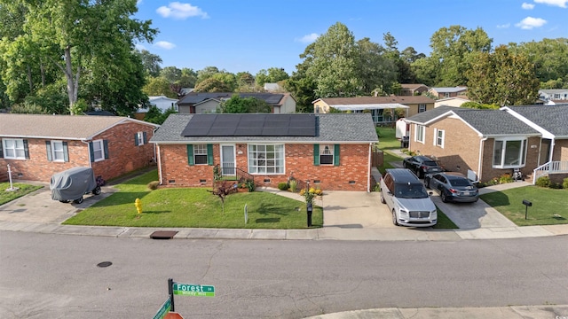 1145 Forest Dr, North Myrtle Beach, SC 29582 - view of front of house featuring crawl space, brick siding, roof mounted solar panels, a residential view, and concrete driveway