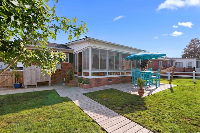 1145 Forest Dr, North Myrtle Beach, SC 29582 - back of property featuring a sunroom, brick siding, and a patio area