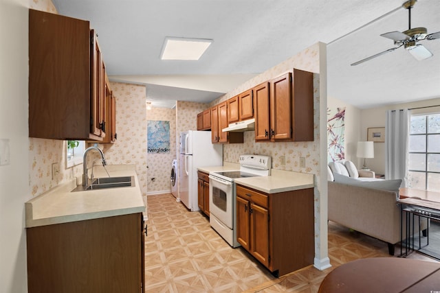 1145 Forest Dr, North Myrtle Beach, SC 29582 - kitchen featuring white range with electric stovetop, under cabinet range hood, wallpapered walls, light countertops, and a ceiling fan