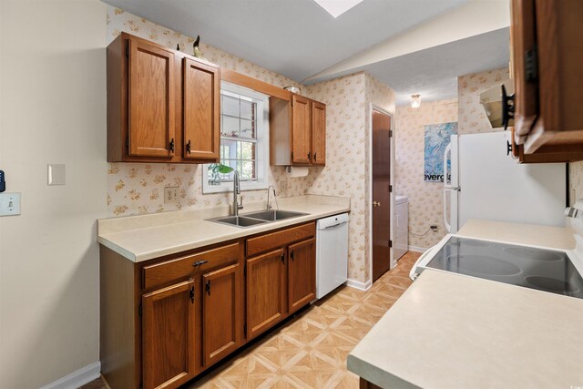 1145 Forest Dr, North Myrtle Beach, SC 29582 - kitchen with white appliances, lofted ceiling, brown cabinetry, light countertops, and wallpapered walls