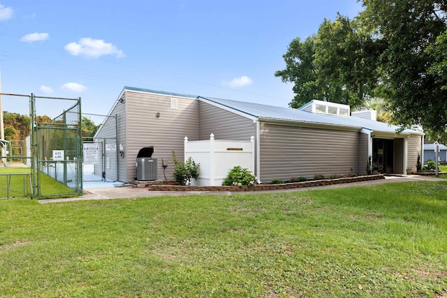 1145 Forest Dr, North Myrtle Beach, SC 29582 - rear view of property featuring a gate, a chimney, and a metal roof