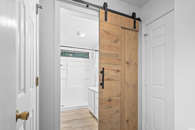 1331 Bermuda Ct, Surfside Beach, SC 29575 - hallway featuring light wood-style flooring and a barn door