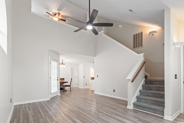1331 Bermuda Ct, Surfside Beach, SC 29575 - unfurnished living room with high vaulted ceiling, ceiling fan, stairs, and wood finished floors