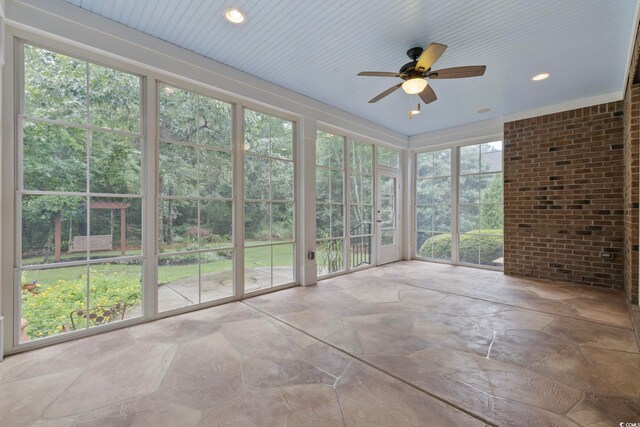 28 Grey Moss Rd, Murrells Inlet, SC 29576 - unfurnished sunroom with stone finish floors and brick wall
