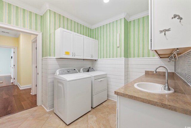 28 Grey Moss Rd, Murrells Inlet, SC 29576 - laundry room with ornamental molding, separate washer and dryer, wallpapered walls, a wainscoted wall, and cabinet space