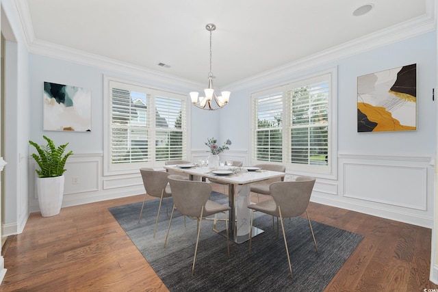 28 Grey Moss Rd, Murrells Inlet, SC 29576 - dining room featuring healthy amount of natural light, crown molding, a chandelier, wood finished floors, and a decorative wall