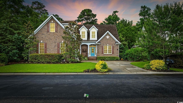 28 Grey Moss Rd, Murrells Inlet, SC 29576 - traditional home with brick siding, a front yard, and concrete driveway