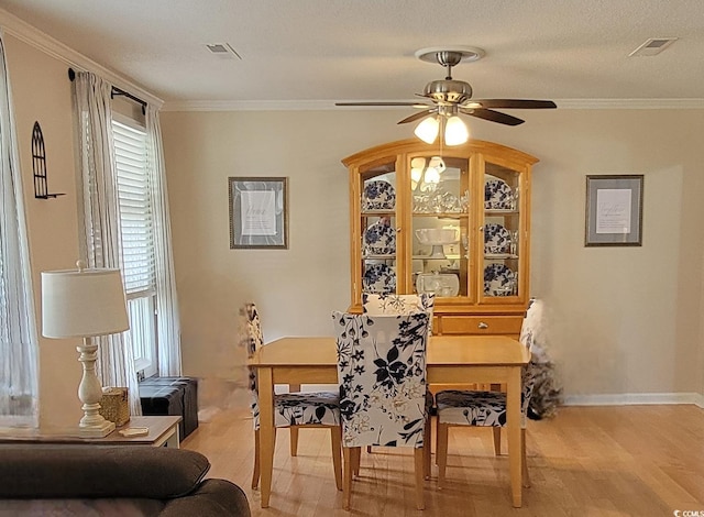 610 Hibiscus Ave Unit 610, Myrtle Beach, SC 29572 - dining room with light wood-style floors, ceiling fan, and ornamental molding