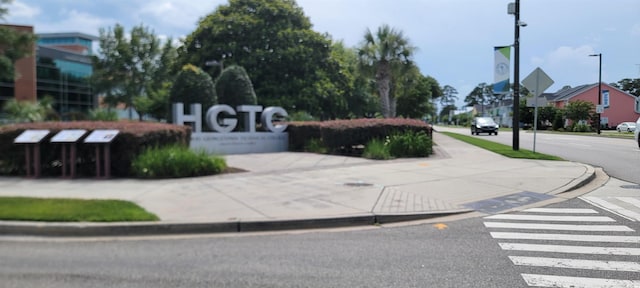 610 Hibiscus Ave Unit 610, Myrtle Beach, SC 29572 - view of asphalt road featuring sidewalks, curbs, traffic signs, and street lighting