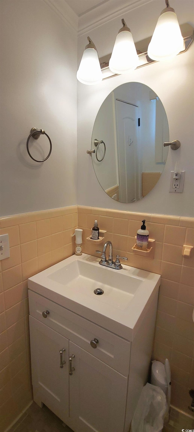 610 Hibiscus Ave Unit 610, Myrtle Beach, SC 29572 - bathroom with tile walls, vanity, a wainscoted wall, and crown molding