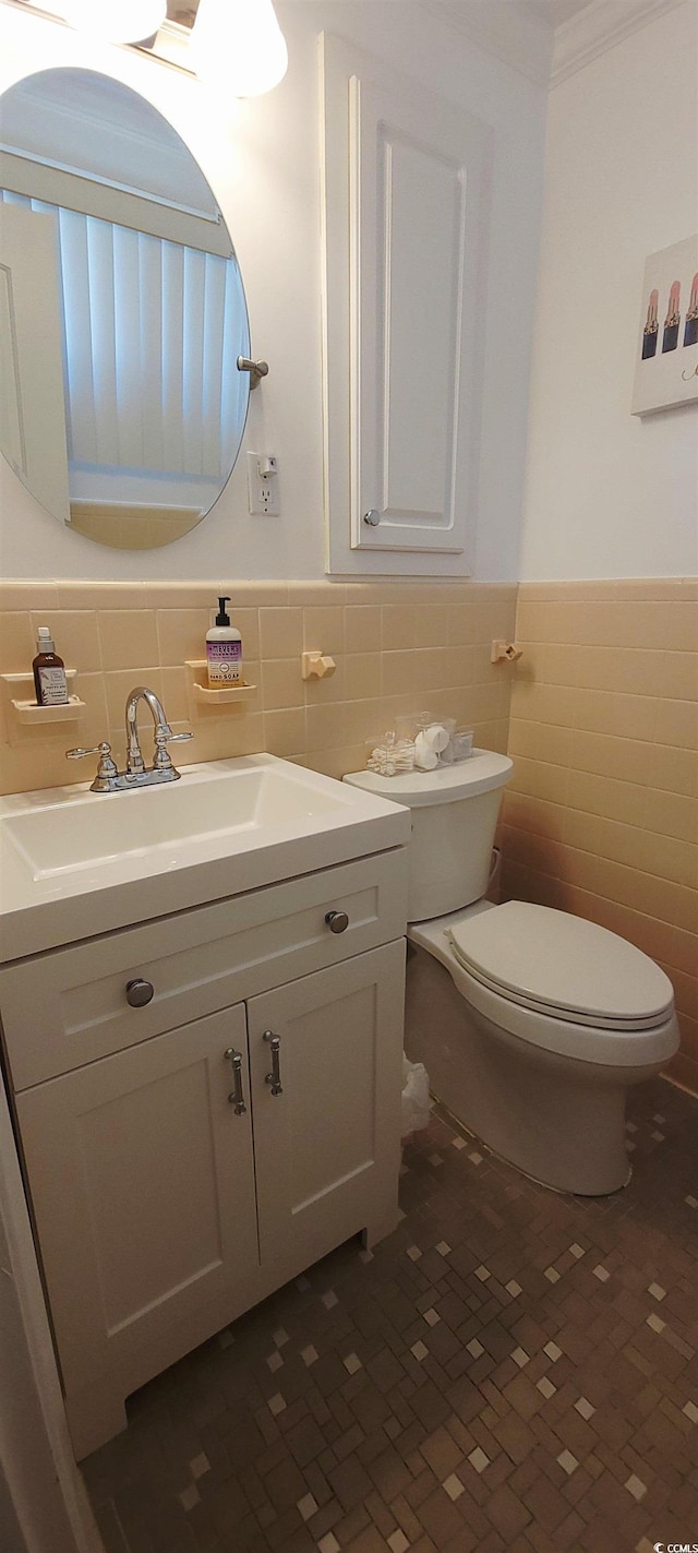 610 Hibiscus Ave Unit 610, Myrtle Beach, SC 29572 - half bath featuring tile walls, vanity, wainscoting, and crown molding
