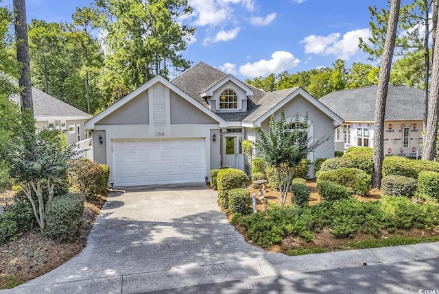 1208 Trisail Ln, North Myrtle Beach, SC 29582 - view of front of property with stucco siding, driveway, a garage, and roof with shingles