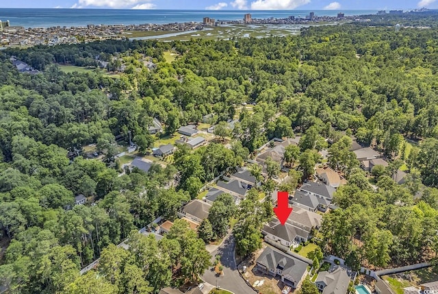 1208 Trisail Ln, North Myrtle Beach, SC 29582 - aerial perspective of suburban area with a large body of water and a heavily wooded area