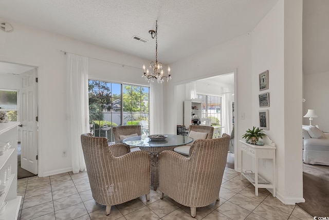 1208 Trisail Ln, North Myrtle Beach, SC 29582 - dining area with plenty of natural light, a chandelier, light tile patterned floors, and a textured ceiling