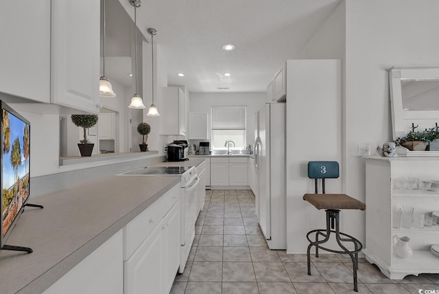 1208 Trisail Ln, North Myrtle Beach, SC 29582 - kitchen with white appliances, white cabinetry, light countertops, light tile patterned floors, and recessed lighting
