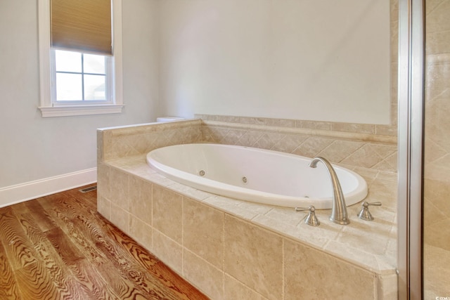 55 Pineberry Dr, Georgetown, SC 29440 - bathroom featuring a jetted tub and wood finished floors