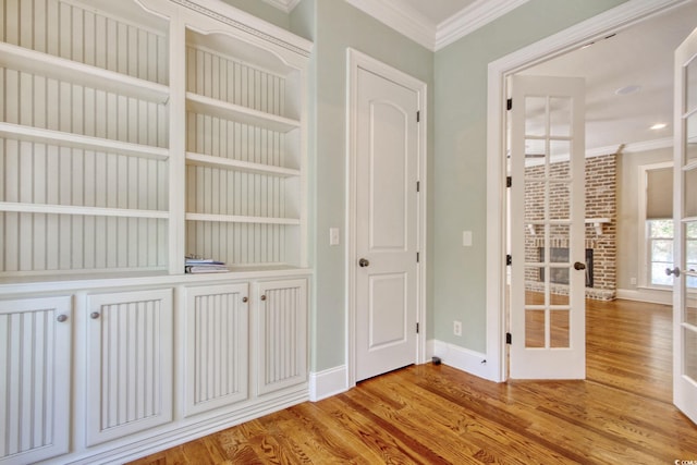 55 Pineberry Dr, Georgetown, SC 29440 - hallway featuring french doors, crown molding, wood finished floors, and recessed lighting