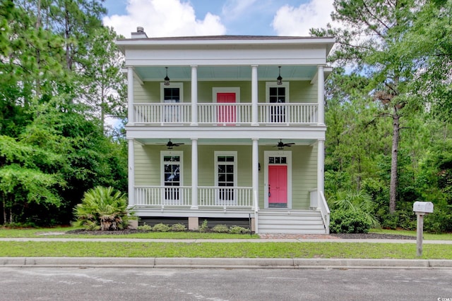 55 Pineberry Dr, Georgetown, SC 29440 - neoclassical home featuring covered porch, ceiling fan, a balcony, and a chimney