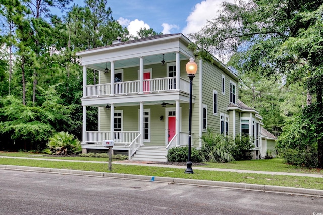 55 Pineberry Dr, Georgetown, SC 29440 - greek revival inspired property featuring covered porch, ceiling fan, a balcony, a chimney, and a front yard