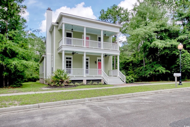 55 Pineberry Dr, Georgetown, SC 29440 - view of front of house featuring a ceiling fan, a porch, a chimney, a balcony, and a front yard