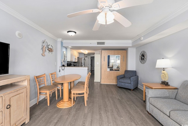 2201 S Ocean Blvd Unit 103, Myrtle Beach, SC 29577 - dining space with ornamental molding, ceiling fan, and wood finished floors