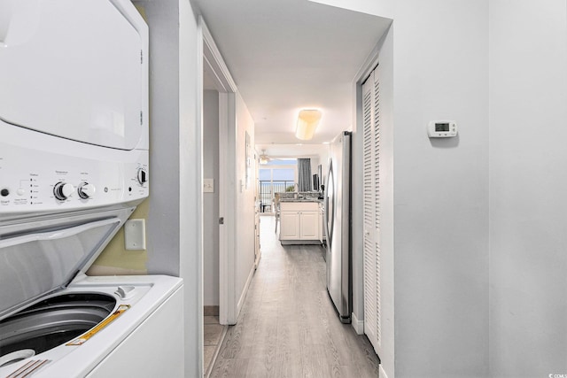 2201 S Ocean Blvd Unit 103, Myrtle Beach, SC 29577 - washroom with stacked washing machine and dryer and light wood-type flooring