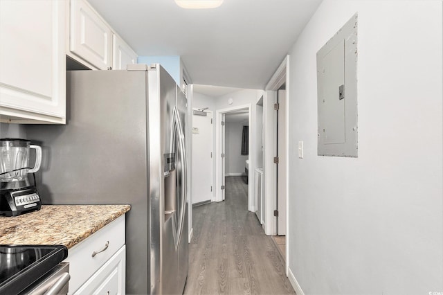 2201 S Ocean Blvd Unit 103, Myrtle Beach, SC 29577 - kitchen with electric panel, stainless steel fridge with ice dispenser, light wood-style floors, white cabinetry, and light stone countertops