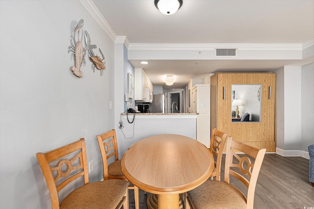 2201 S Ocean Blvd Unit 103, Myrtle Beach, SC 29577 - dining room featuring crown molding and wood finished floors