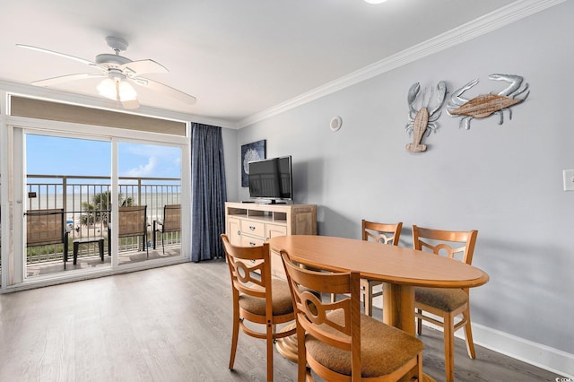 2201 S Ocean Blvd Unit 103, Myrtle Beach, SC 29577 - dining room featuring ornamental molding, a ceiling fan, and light wood finished floors