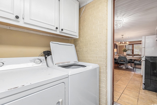 1416 Edge Dr, North Myrtle Beach, SC 29582 - laundry room with cabinet space, washing machine and dryer, light tile patterned flooring, and a chandelier