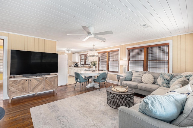 1416 Edge Dr, North Myrtle Beach, SC 29582 - living area featuring a ceiling fan, a chandelier, hardwood / wood-style flooring, and wood walls