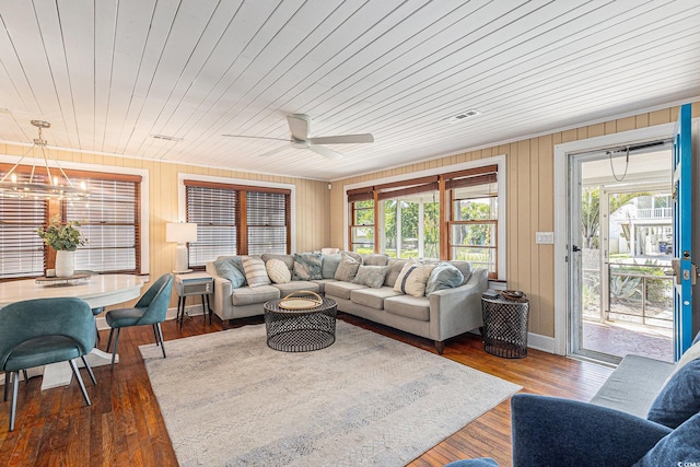 1416 Edge Dr, North Myrtle Beach, SC 29582 - living room featuring plenty of natural light, ceiling fan, a chandelier, wooden walls, and wood finished floors