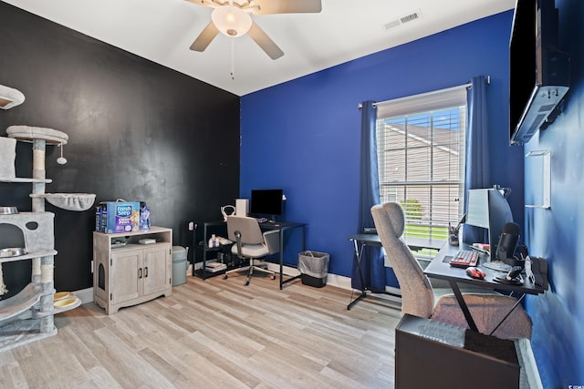 2885 Desert Rose St, Little River, SC 29566 - home office featuring ceiling fan, light wood-style floors, and an accent wall