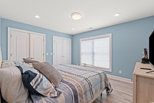 2885 Desert Rose St, Little River, SC 29566 - bedroom featuring light wood-style flooring, recessed lighting, and two closets