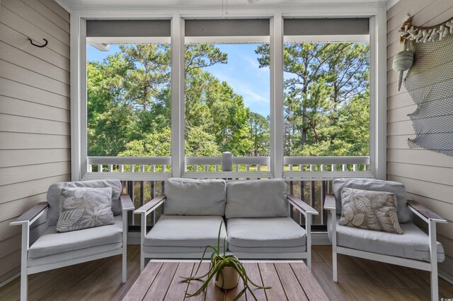 6015 Catalina Dr Unit 932, North Myrtle Beach, SC 29582 - sunroom featuring outdoor lounge area and view of wooded area