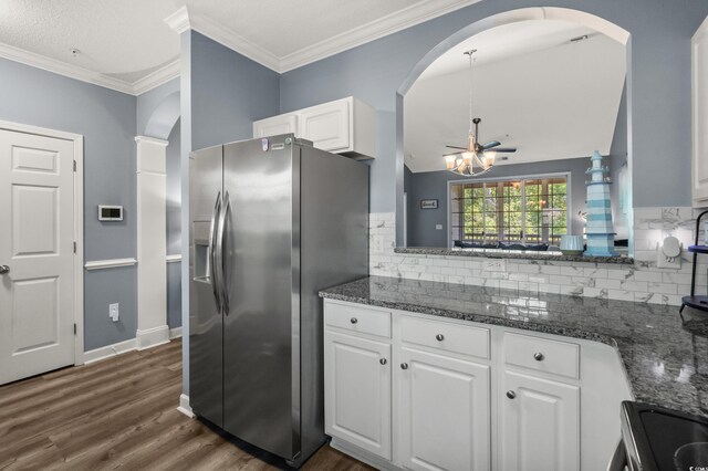 6015 Catalina Dr Unit 932, North Myrtle Beach, SC 29582 - kitchen with stainless steel fridge, arched walkways, white cabinets, tasteful backsplash, and ornamental molding