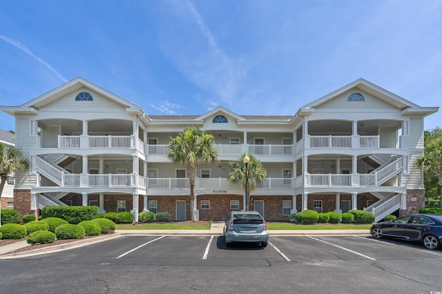6015 Catalina Dr Unit 932, North Myrtle Beach, SC 29582 - view of apartment building / complex featuring uncovered parking and stairs
